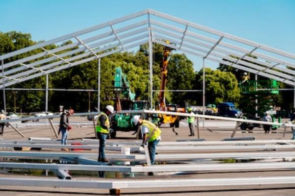 Workers build a huge tent to house migrants, in the Bronx, in September 2022.