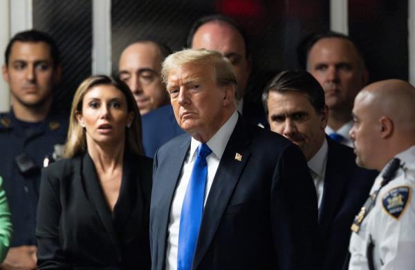 A man holds a placard outside Manhattan criminal court following the verdict in former U.S. president Do<em></em>nald Trump's criminal trial.