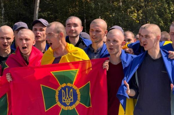 Ukrainian priso<em></em>ners of war (POWs) react after a swap, amid Russia's attack on Ukraine, at an unknown location in Ukraine, in this handout picture