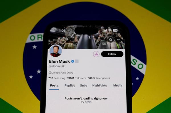 Elon Musk's X social network account blocked, displayed on a mobile screen, following suspension by Brazil's telecommunications regulator