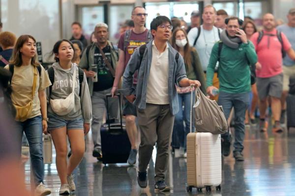 A group of people walking with luggage at Salt Lake City Internatio<em></em>nal Airport on July 3, 2024.