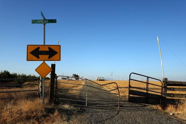 Street sign near a large parcel of land recently purchased and planned for housing and clean energy community development in Solano County, California