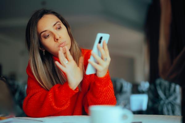 A woman swiping on her phone. 