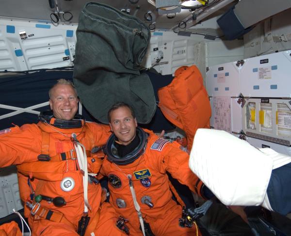 NASA astro<em></em>nauts Timothy L. Kopra, left, and Thomas H. Marshburn enjoy the first few minutes of weightlessness after Endeavour reached orbit