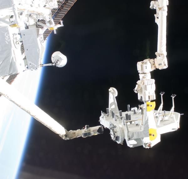 Christopher J. Cassidy, left, and Thomas H. Marshburn exchange space station batteries during the mission's fourth spacewalk