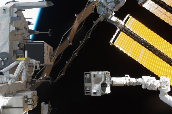 Christopher J. Cassidy, left, and David A. Wolf during the mission's third spacewalk