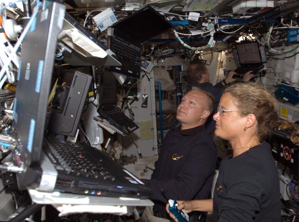 NASA astro<em></em>naut Douglas G. Hurley, left, and Canadian Space Agency astro<em></em>naut Julie Payette operate the station's robotic arm during the second spacewalk