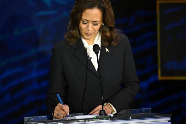 US Vice President and Democratic presidential candidate Kamala Harris takes notes as former US President and Republican presidential candidate Do<em></em>nald Trump speaks during a presidential debate at the Natio<em></em>nal Co<em></em>nstitution Center in Philadelphia, Pennsylvania, on September 10, 2024. 