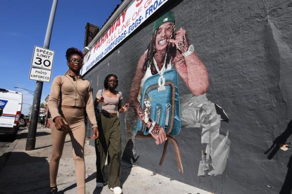Young women standing in front of the King Von mural on Chicago's infamous South Side 'O Block'