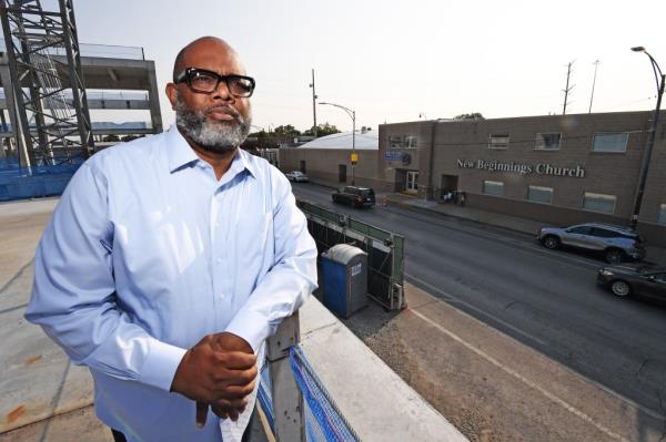 Pastor Corey Brooks, 55, leaning on a railing in south side of Chicago