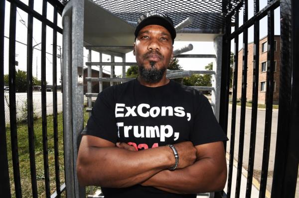 Tyrone Muhammed, aged 53 and former gang member, now street activist, standing in a playground promoting violence prevention in Chicago's inner city