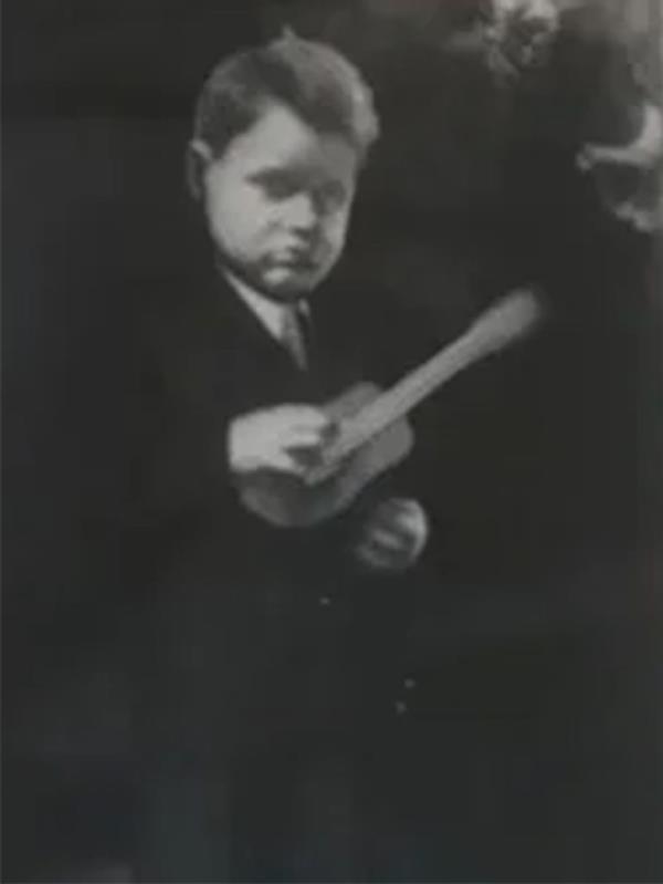 A boy in a suit holding a ba<em></em>seball bat, identified as Luis, who was found safe and well thanks to his dedicated niece.