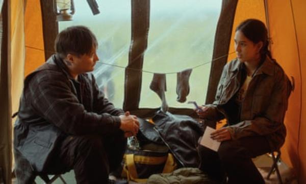 Aslat Mahtte Gaup and Sarah Olaussen talk as they sit opposite each other in a tent