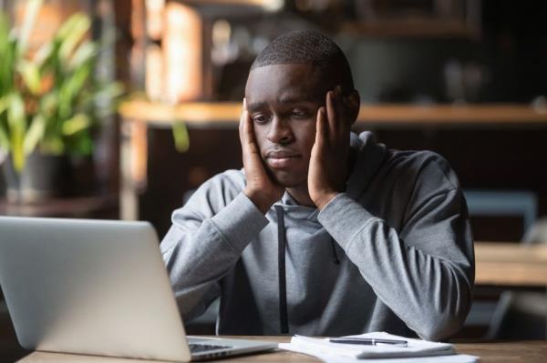 Black Man Looking Sad and Alone at Work, co<em></em>ntagious conditions