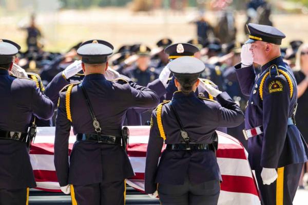 Members of the Dallas Police Ho<em></em>nor Guard salute the casket of officer Darron Burks during his funeral at Watermark Community Church on Sept. 7, 2024.