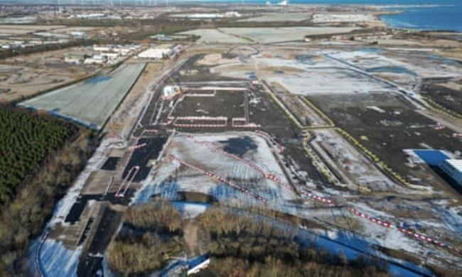 A large but almost completely unbuilt building site, viewed from the air