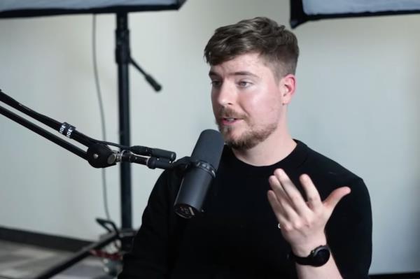 MrBeast speaking into a microphone during an interview.