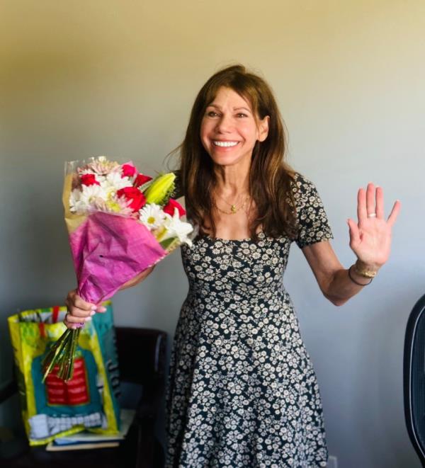 Theresa Nist poses with a bouquet of flowers.