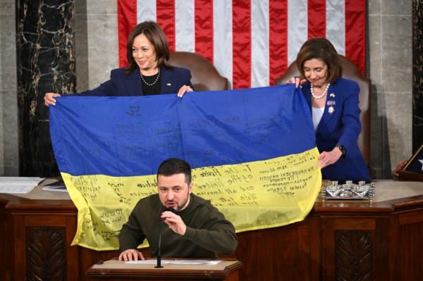 Ukraine's President Volodymyr Zelensky speaks after giving a Ukrainian natio<em></em>nal flag to US House Speaker Nancy Pelosi (D-CA) and US Vice President Kamala Harris (L) during his address the US Co<em></em>ngress at the US Capitol in Washington, DC on December 21, 2022. 