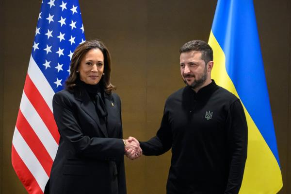 US Vice President Kamala Harris (L) shakes hands with Ukraine's President Volodymyr Zelensky during a meeting on the sideline of the Summit on peace in Ukraine, at the luxury Burgenstock resort, near Lucerne, on June 15, 2024.