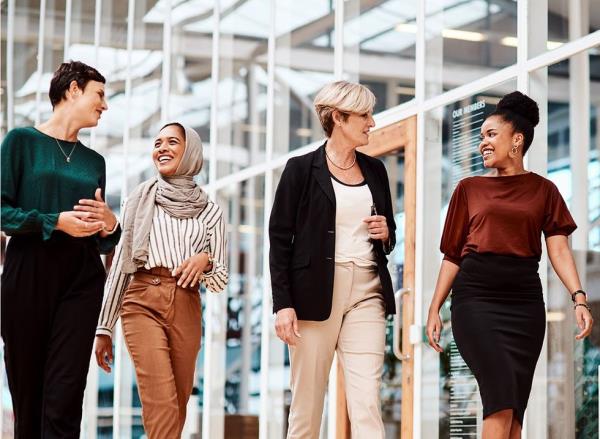 A group of four women walking while at work