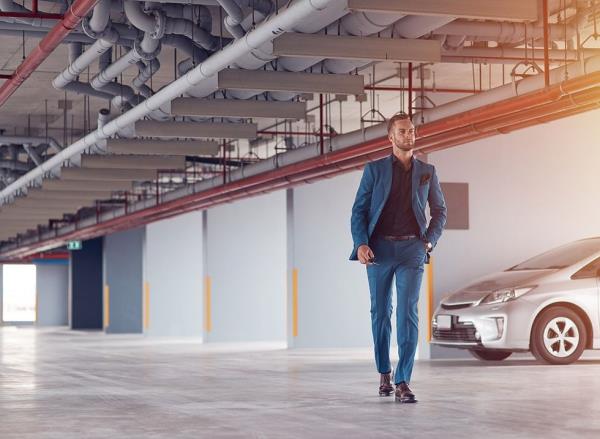 Businessman walking through parking lot
