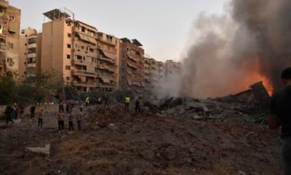 Lebanese civil defence and firefighting teams arrive at the scene of an Israeli airstrike on southern Beirut