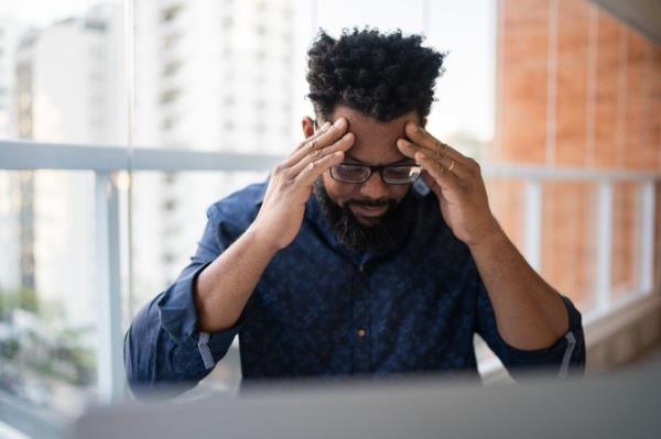 A man working with headache at home
