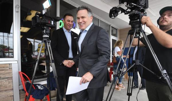 Dave McCormick, Republican nominee for U.S. Senate in Pennsylvania, center, arrives to speak to a small crowd at Pano's Restaurant in Erie on Sept. 26, 2024.