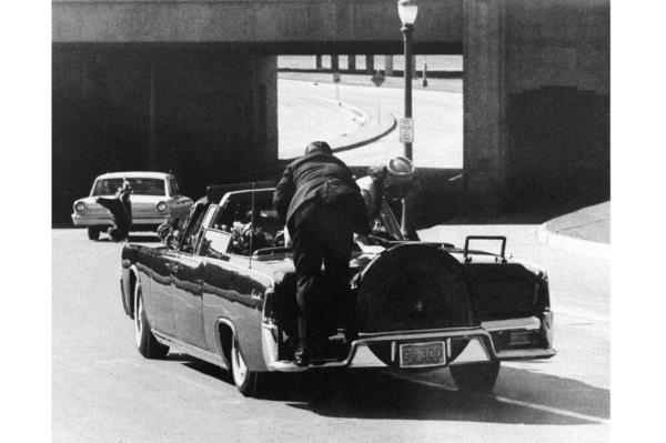 Secret Service Agent Clint Hill can be seen on the back of the limousine in the film.