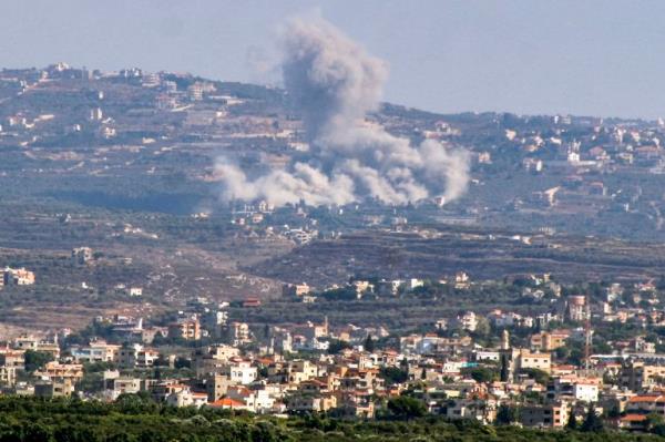 A smoke cloud erupts following an Israeil air strike on the village of Jbal el-Botm in southern Lebanon on September 28, 2024. (Photo by Kawnat HAJU / AFP)