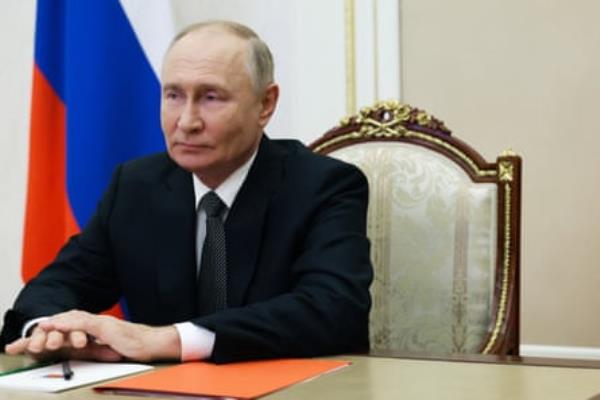 Vladimir Putin seated at a desk