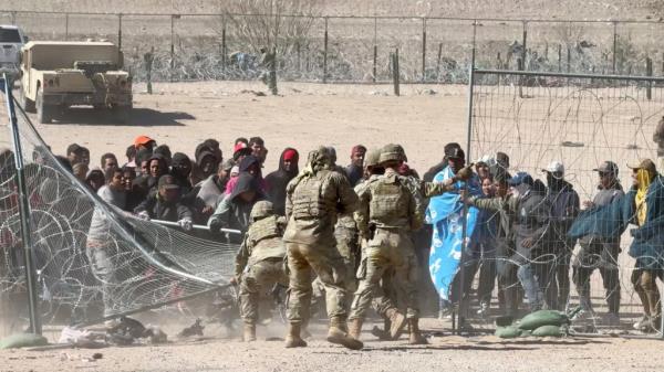 Texas Natio<em></em>nal Guard pushed back a large group of almost 60 migrants who crossed the border illegally and breached the co<em></em>ncertina wire barriers set up along the US side of the Rio Grande river. The migrants had made it to the actual border wall but were forced back across the razor wire defenses by soldiers telling them to enter the US at a legal point of entry to claim asylum, pointing to the Zaragoza bridge above them.