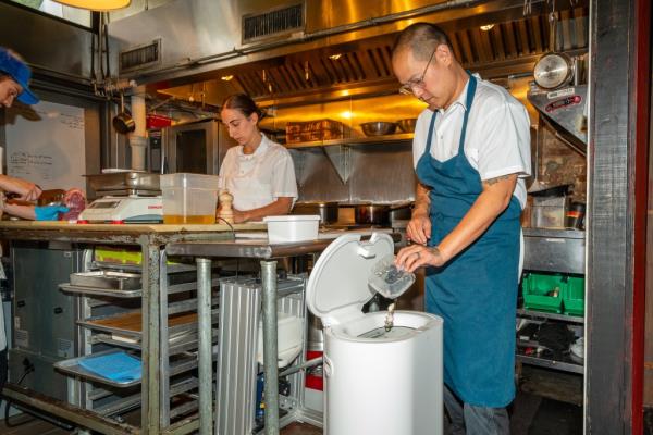 Jeremiah Stone, Chef and Owner of Bar Contra, with a Mill food recycler in the Bar Co<em></em>ntra kitchen