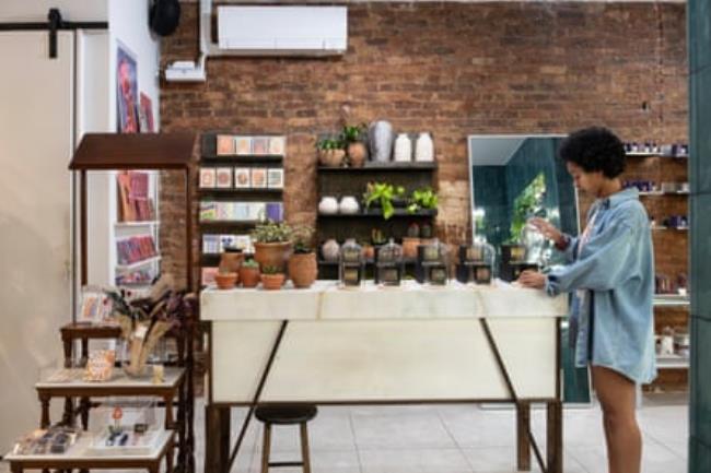 A woman looks at merchandise in a tastefully furnished store.