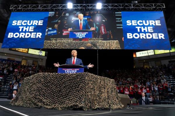 Trump speaks in Prescott Valley, Arizona as two large "Secure The Border" signs hang above his head on Oct. 13, 2024.