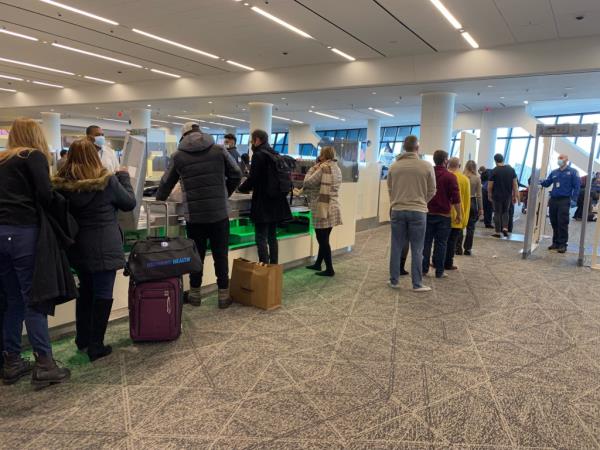 Crowds of travelers waiting for Security check, LaGuardia Airport, New York