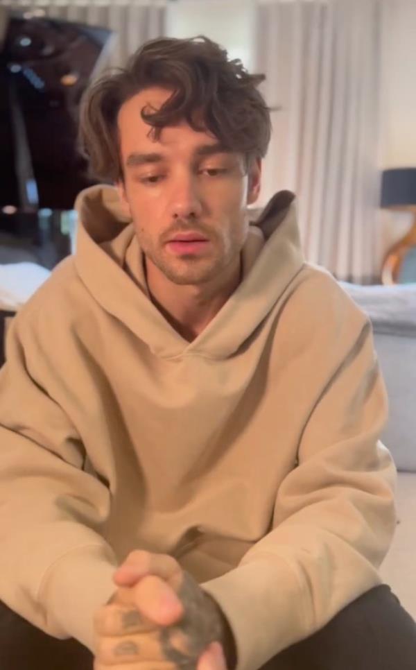 Liam Payne in a hoodie, looking distressed, following announcement of hospitalization due to serious kidney infection and tour cancellation