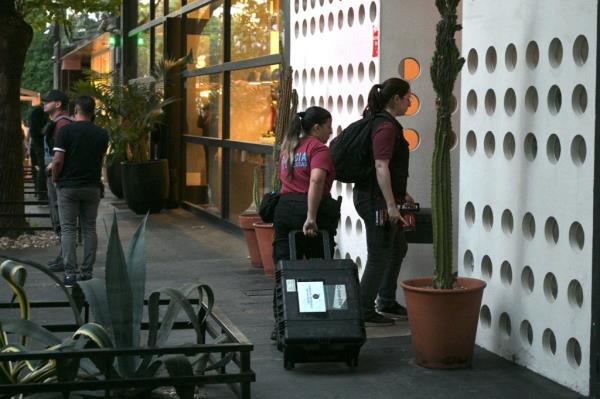 The forensic team arriving at the hotel on Oct. 16.