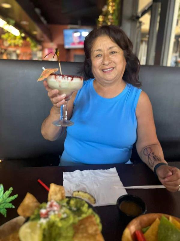 Pamrla Ferreyra holding up margarita at restuarant