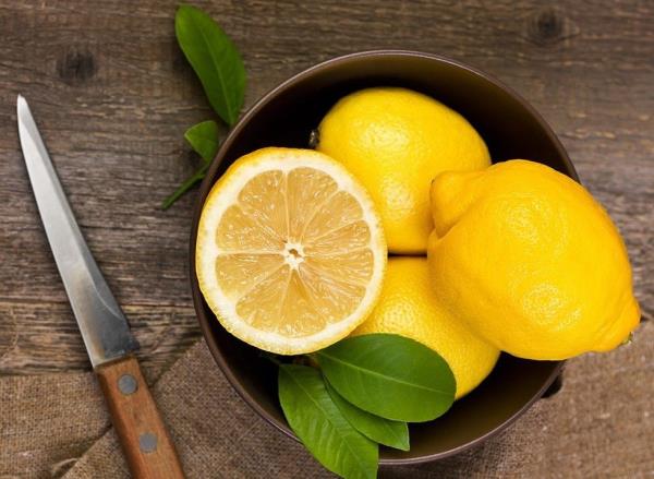 Lemons in a bowl on a wooden table