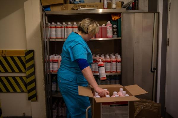 Sophie Watkinson, an embalmer, unloading embalming fluids at Rowland Brothers funeral home in Croydon, South Lo<em></em>ndon amidst Covid-19 pandemic