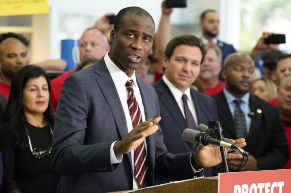 Florida Surgeon General Dr. Joseph Ladapo gestures as speaks to supporters and members of the media before a bill signing by Gov. Ron DeSantis Thursday, Nov. 18, 2021, in Brandon, Florida