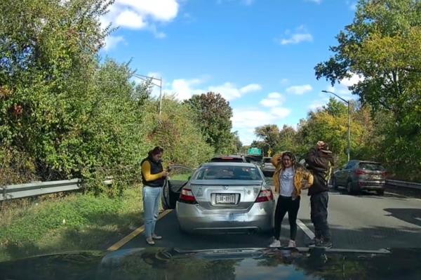 The three passengers act inn disbelief after their car seemingly backed into another car as part of an attempted insurance fraud scheme.