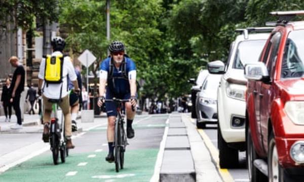 Cyclists use a cycle lane alo<em></em>ngside busy traffic in Sydney.