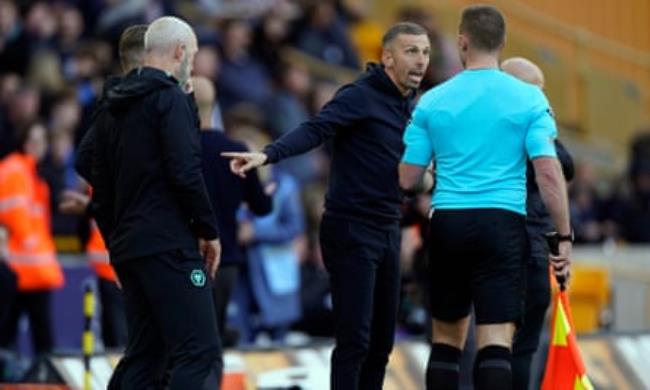 Gary O'Neil speaks to the assistant referee