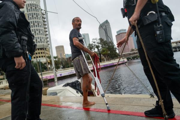 Tampa police try to persuade a local resident who is living on his boat known as Jay and nicknamed Lieutenant Dan to leave for his safety as Tampa prepares for the arrival of Hurricane Milton on October 09, 2024 in Tampa, Florida