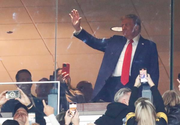 Former President Do<em></em>nald Trump waving to the crowd at a Pittsburgh Steelers versus New York Jets game from the VIP box
