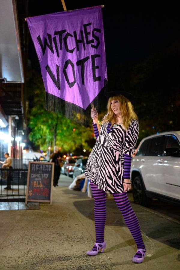 Mari Gustafson holding Witches Vote sign 
