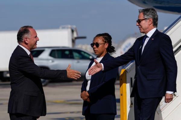 Israeli deplomat Gil Haskel (L) welcomes US Secretary of State Antony Bl<em></em>inken as he disembarks from his plane upon arrival at the Ben Gurion Airport in Tel Aviv on October 22, 2024. US Secretary of State Antony Bl<em></em>inken landed on October 22 in Israel in a renewed push for a Gaza ceasefire, an AFP reporter travelling with him said, days after Israeli forces killed Hamas leader Yahya Sinwar. (Photo by Nathan Howard / POOL / AFP)